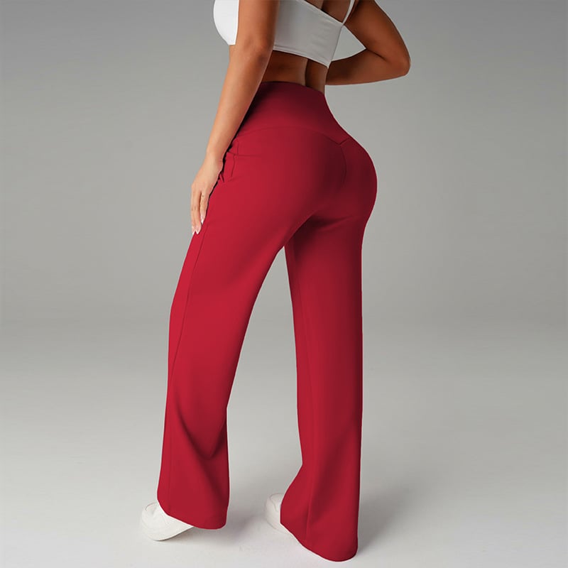 Pantalon femme à jambes larges et droites, taille haute, tissu extensible, en coloris noir, porté par une femme.