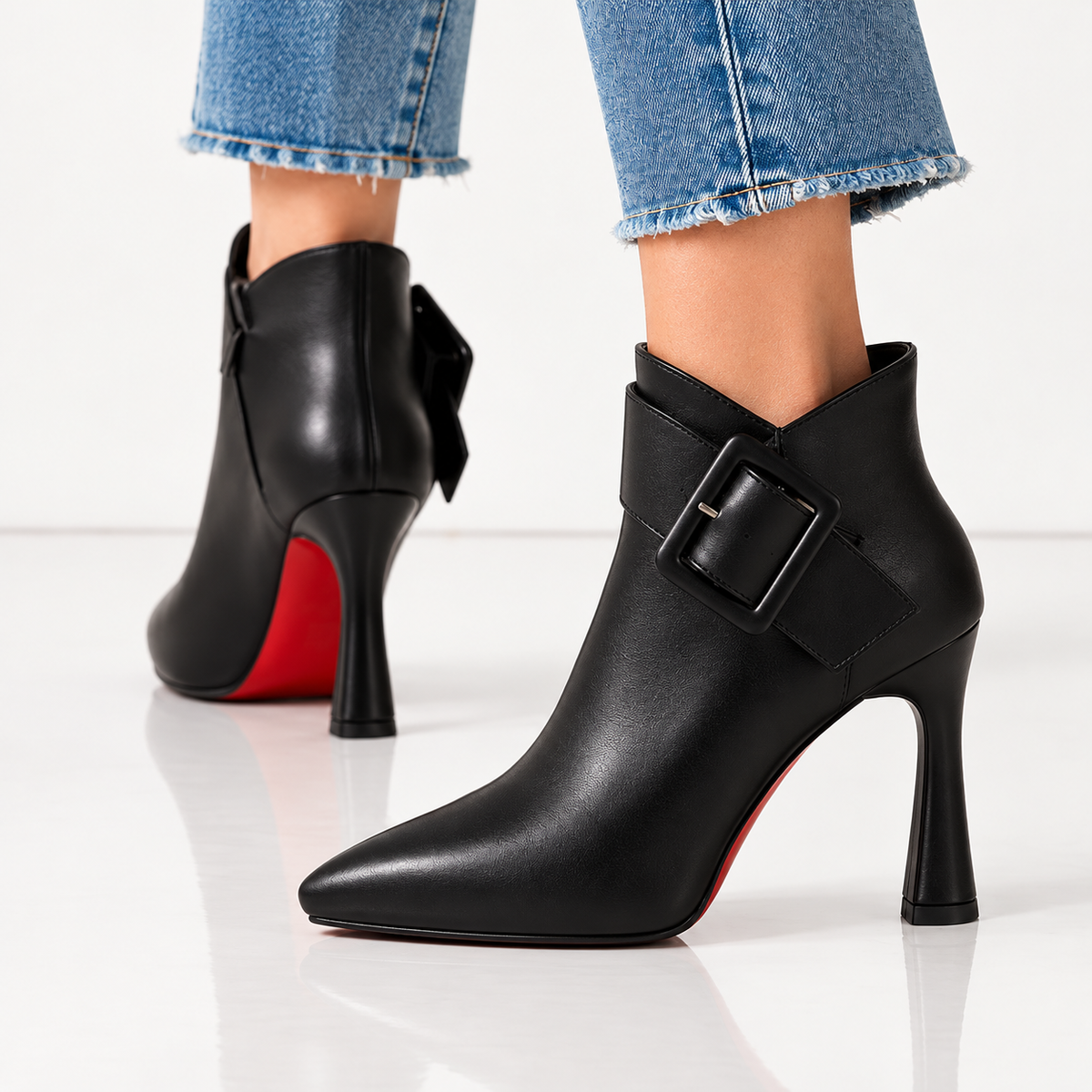 Bottines à boucle en cuir noir Danoir Paris sur sol blanc brillant