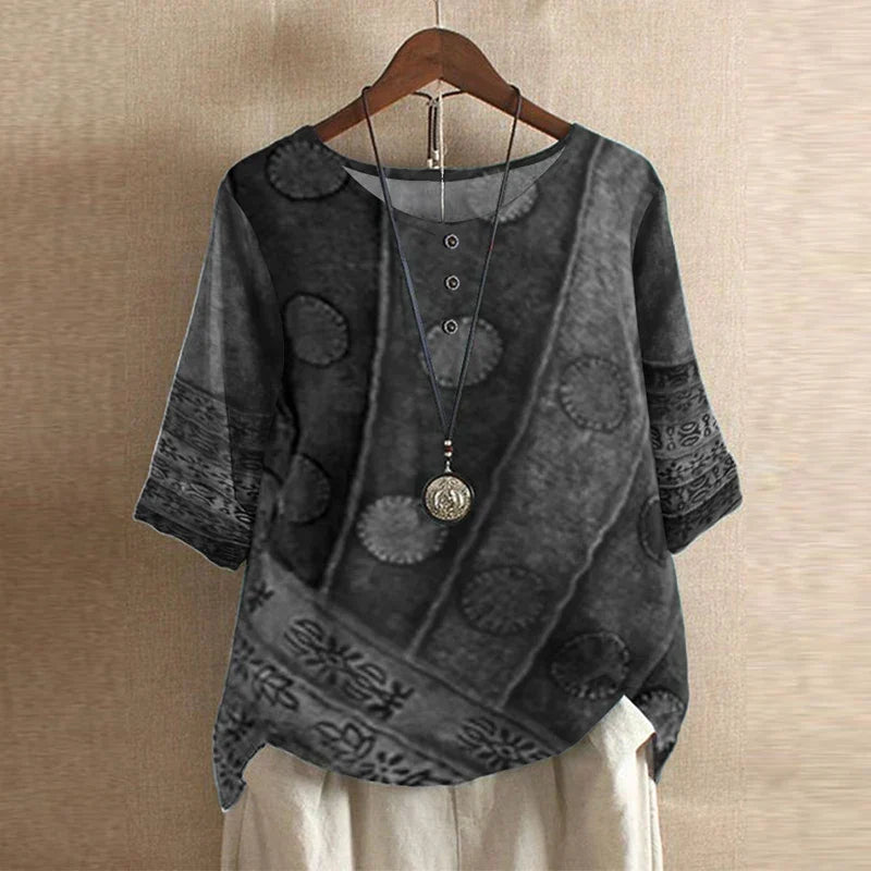 Blouse Anya™ Danoir Paris, style rétro avec motifs floraux, manches longues et col en V, tissu léger et élégant.