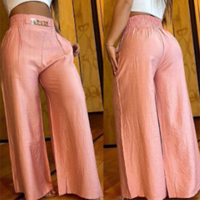 Pantalon large taille haute sculptant Évelyne™ de Danoir Paris, en tissu fluide noir, porté avec haut blanc dans une image élégante.
