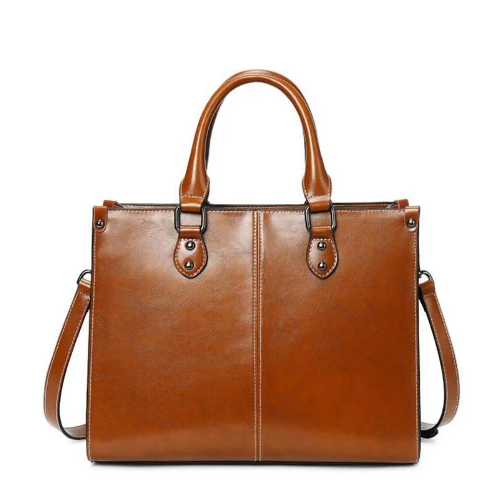 Sac à main Danoir Paris Seraphina en cuir cognac, élégant et pratique, avec poignées et détails raffinés.