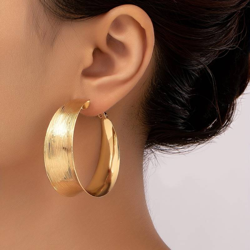 Boucles d'oreilles créoles dorées vintage de Danoir Paris, élégantes et classiques, visibles avec détails en or brillant.