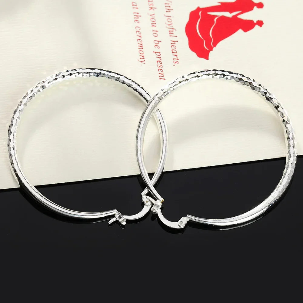 Boucles d'oreilles en argent sterling Danoir Paris avec design élégant et finition brillante, visibles en image.