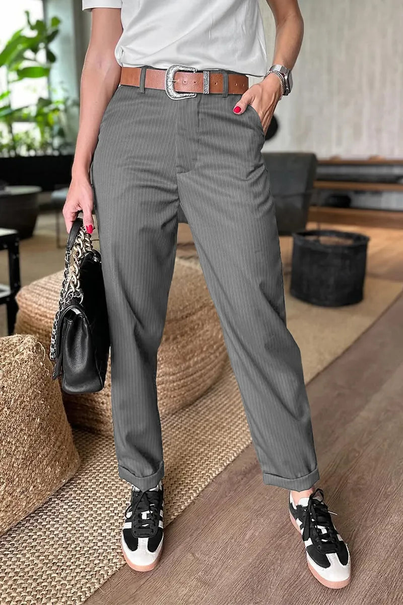 Pantalon élégant polyvalent Mathilda de Danoir Paris, tissu fluide, coupe ajustée, couleur neutre, porté avec chemise blanche.