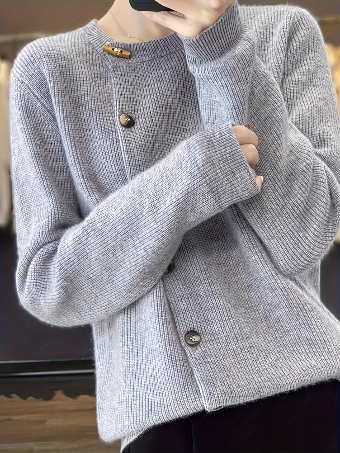 Cardigan classique élégant Danoir Paris Gemma, en laine douce beige avec boutons, porté sur un mannequin blanc.