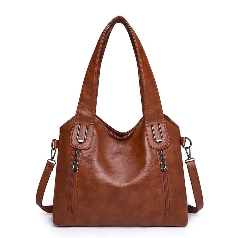 Sac à bandoulière Lydia Danoir Paris en cuir marron avec design vintage, élégant et pratique pour un style sophistiqué.