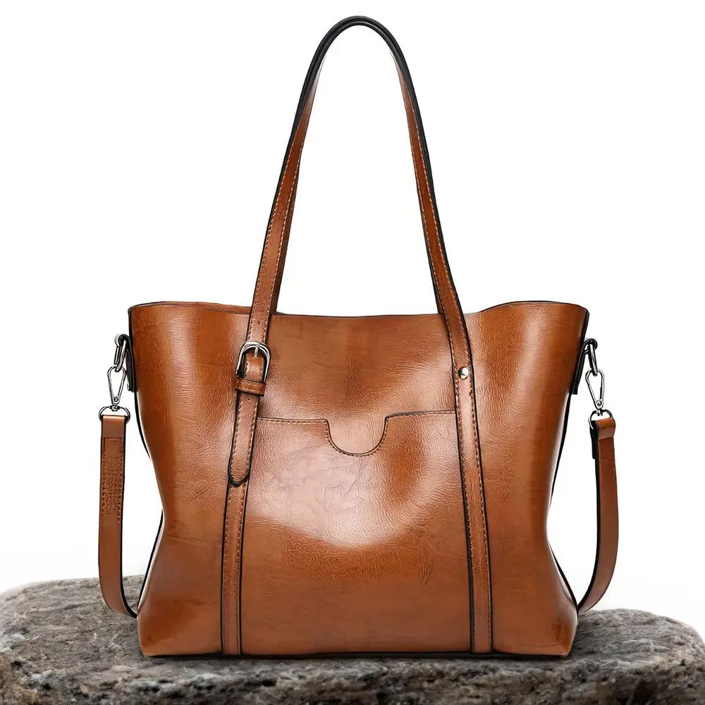 Sac à main élégant Lydia de Danoir Paris en cuir marron, avec poignées et détails sophistiqués, pour un style chic et tendance.