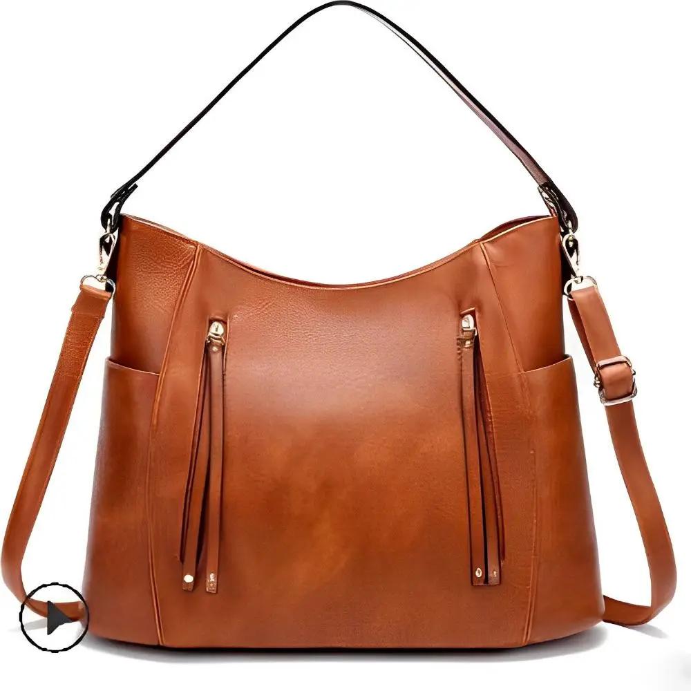 Sac à bandoulière vintage Tessa de Danoir Paris en cuir marron avec design classique, visible avec détails et texture.