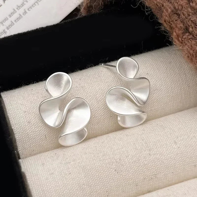 Boucles d'oreilles en argent et or 18K Danoir Paris avec design élégant et finition brillante.