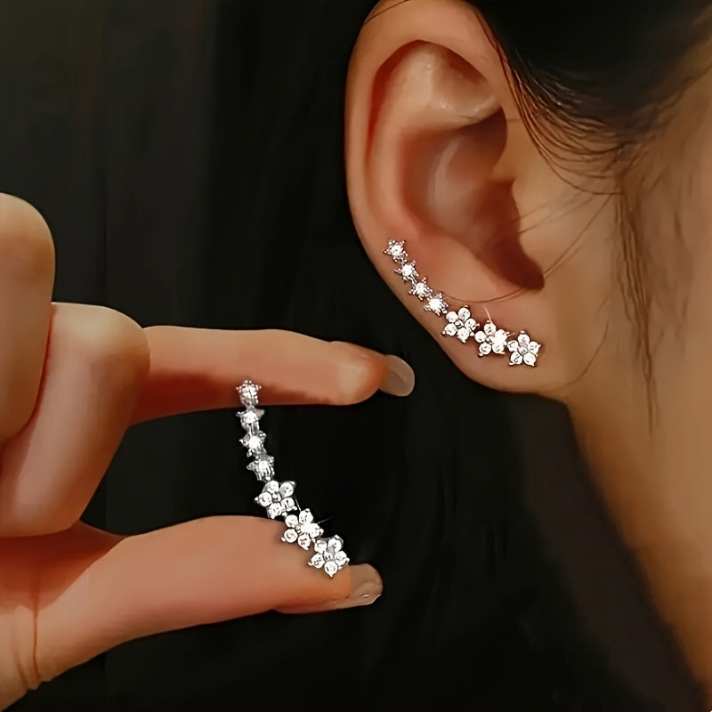 Boucles d'oreilles florales intemporelles Danoir Paris avec motifs en or rose et détails élégants, visibles sur l'image.
