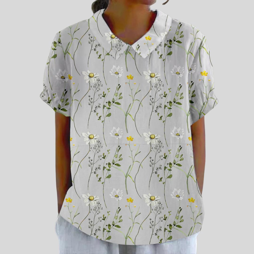 Blouse Aurore Danoir Paris à motifs marguerites sauvages en coton avec manches longues et col en V, vue de face.