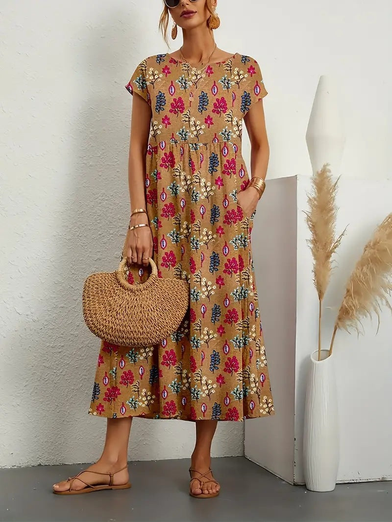 Robe florale élégante Gia de Danoir Paris avec motif coloré, tissu léger et coupe féminine, portée sur un fond neutre.