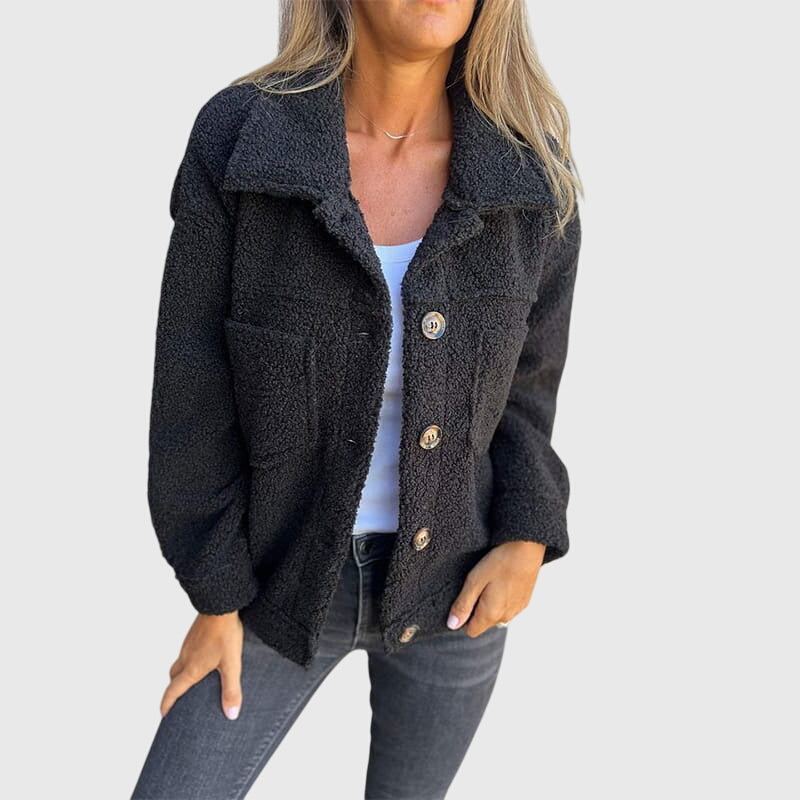 Veste élégante Mila de Danoir Paris, en tissu noir avec boutons, portée sur un fond neutre, style chic et sophistiqué.