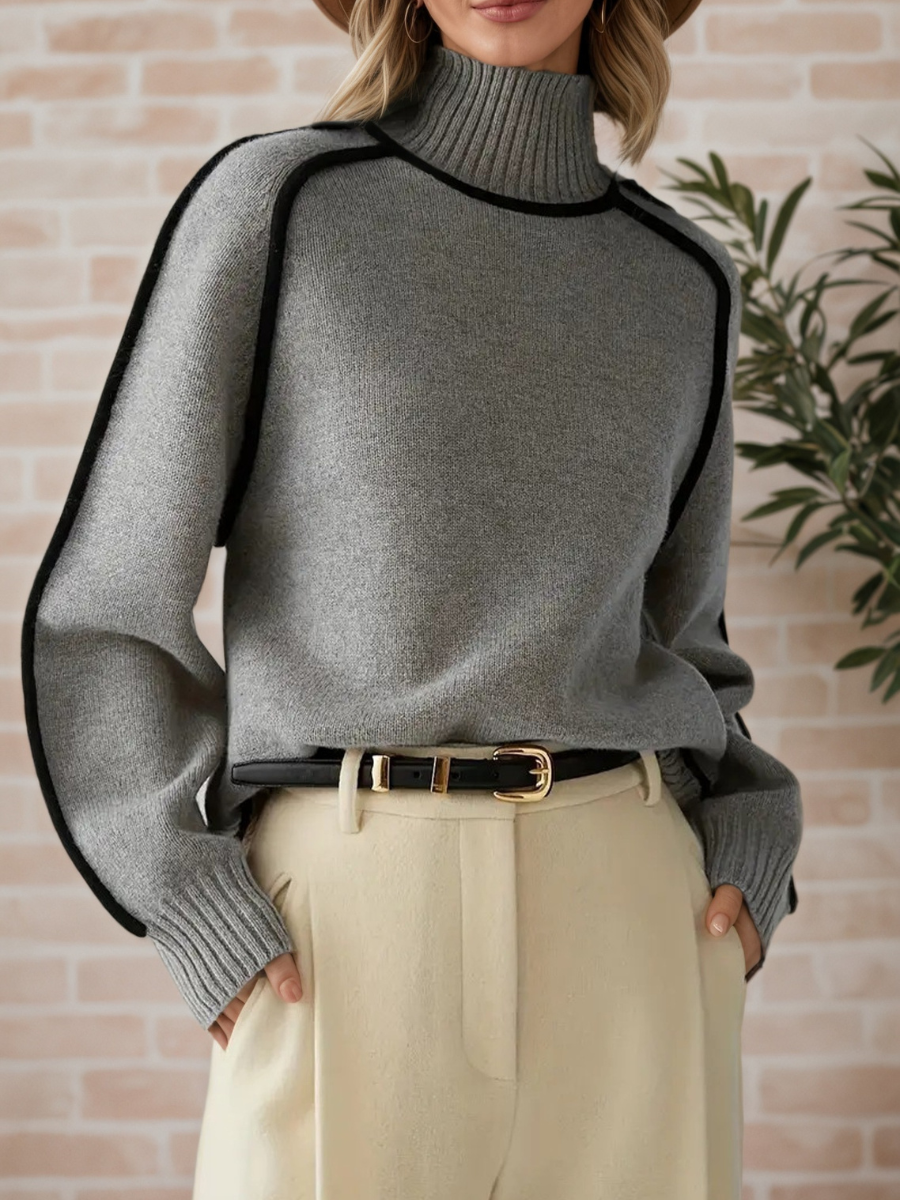 Pull élégant Donna à col haut Danoir Paris, parfait pour l’automne, en tissu doux et chaud, porté en mode décontractée.