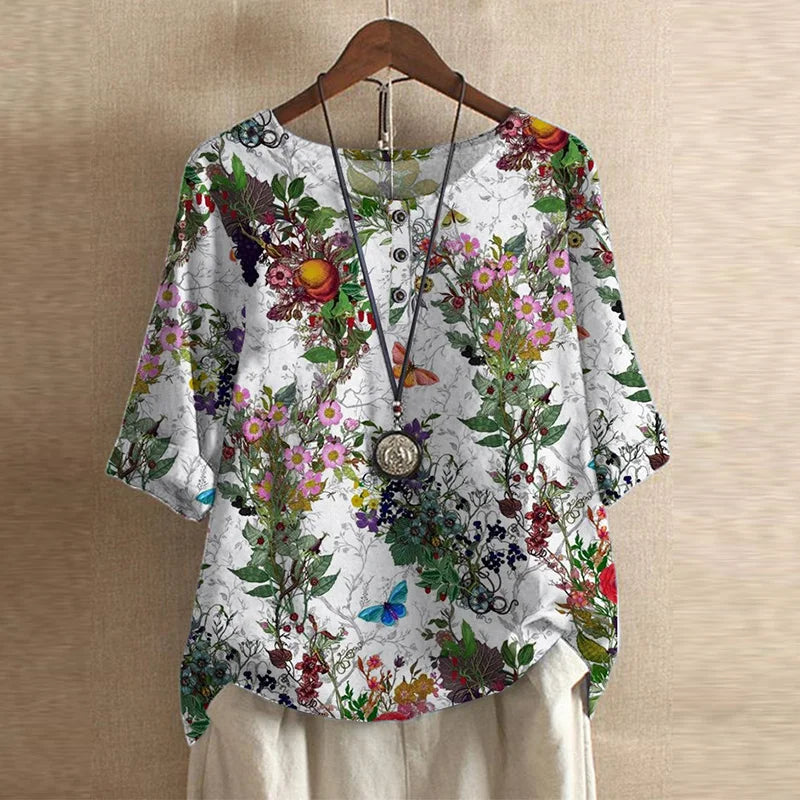 Blouse Anya™ Danoir Paris avec style rétro, manches longues, col en V et motifs floraux, élégante et vintage.