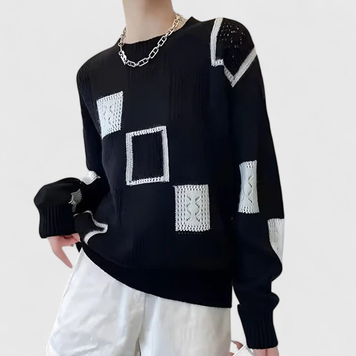 Pull sophistiqué Danoir Paris en noir, torsadé, avec col en V et finitions élégantes, porté par un mannequin.