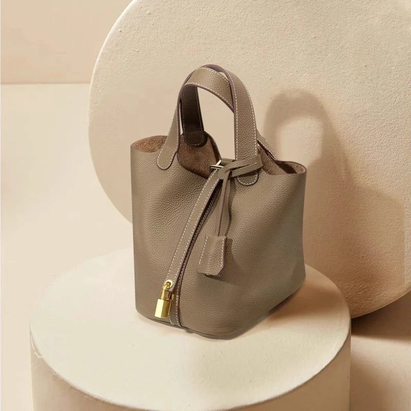 Sac seau Portico en cuir marron Danoir Paris, fermeture à cordon et poignées pour un style élégant et pratique.