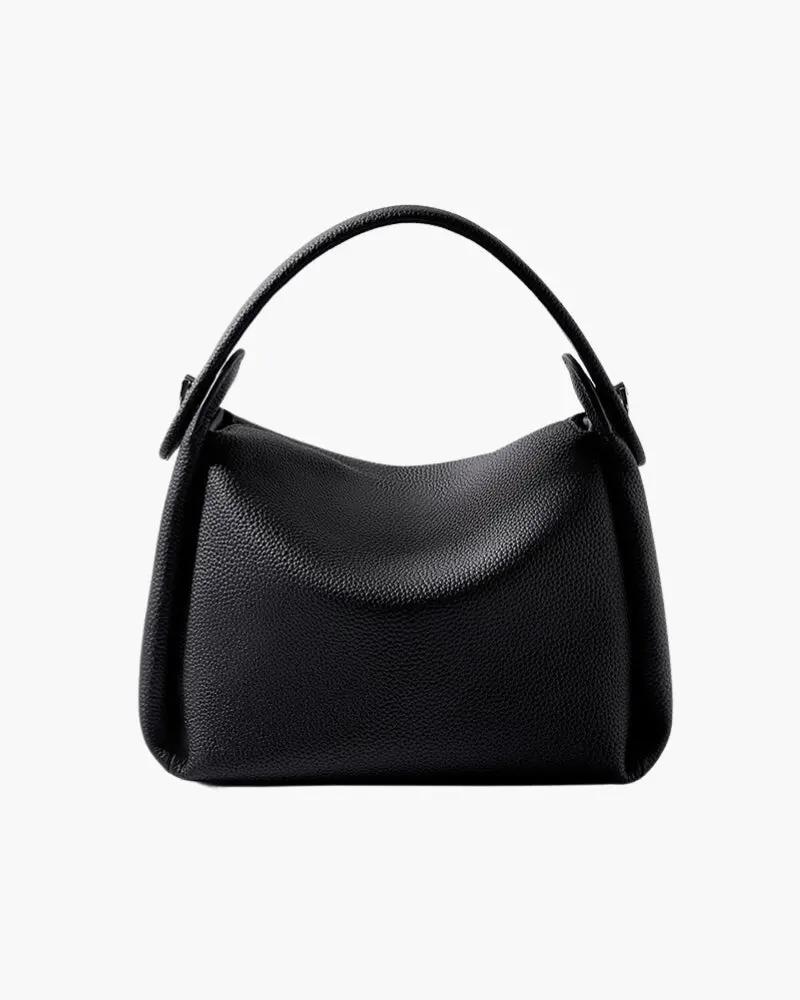Sac à main Classy Lady Danoir Paris en cuir noir avec poignées en or et détails élégants, posé sur une surface en bois.