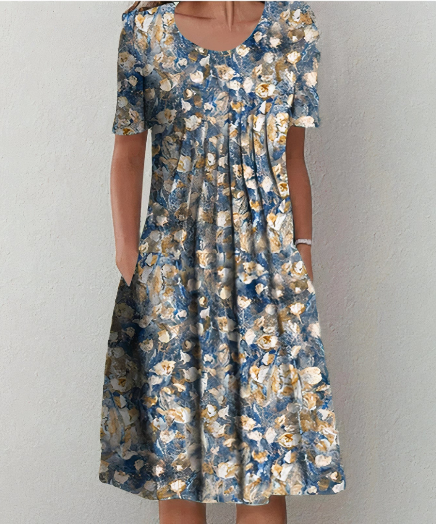 Robe florale élégante Danoir Paris pour femme avec motifs colorés, tissu léger et coupe fluide, vue de face sur mannequin.