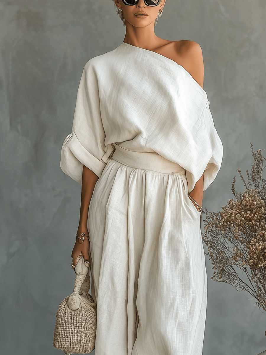 Ensemble de deux pièces Mila™ Danoir Paris avec encolure bardot, top et pantalon élégants, en tissu léger blanc.