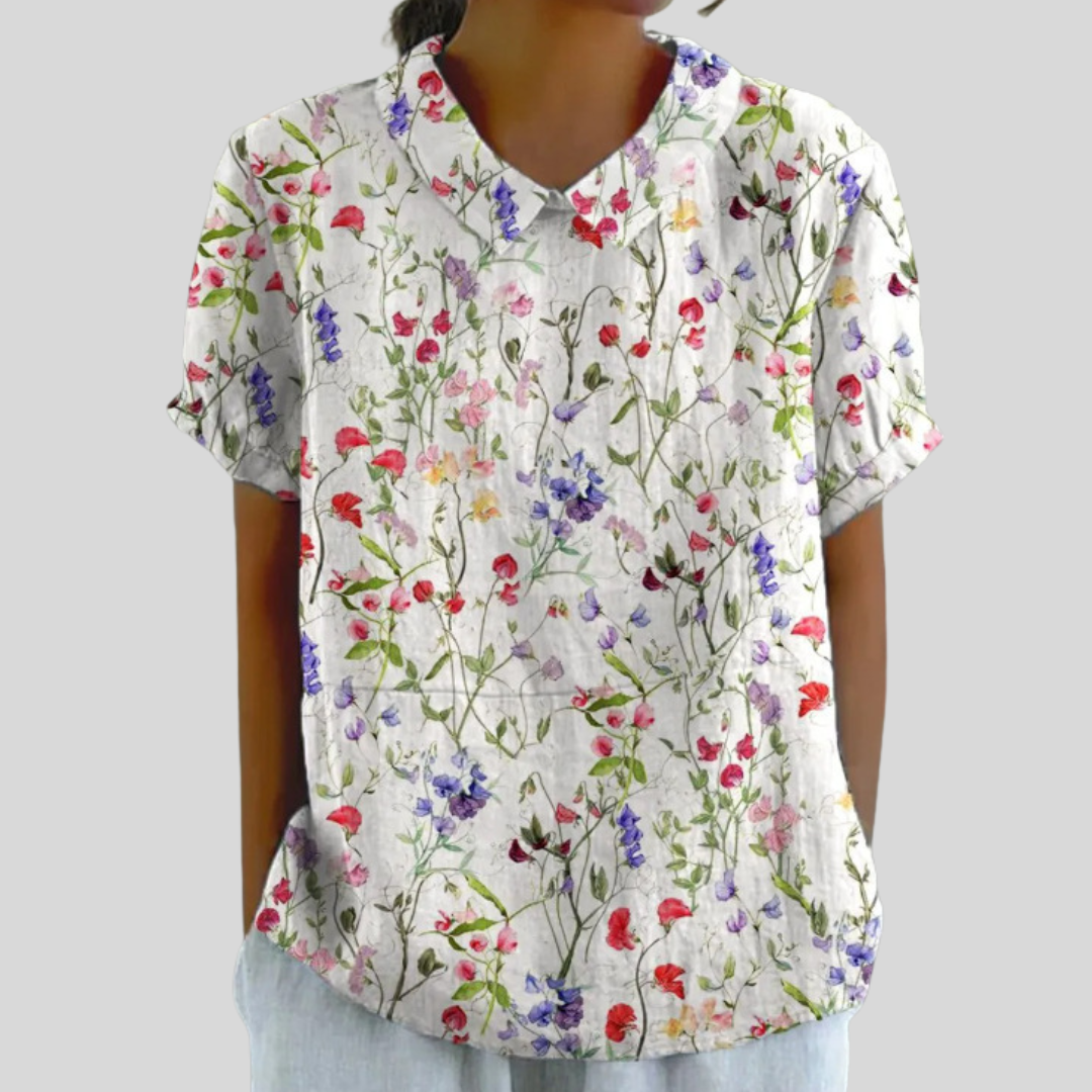 Blouse Clarélia™ à fleurs délicates de Danoir Paris, tissu léger beige et noir, style élégant et féminin.