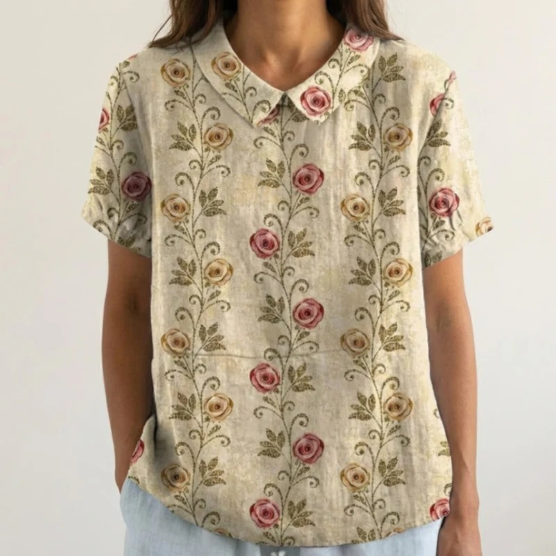 Blouse Clarélia™ à fleurs délicates de Danoir Paris, en tissu léger et élégant, portée avec manches longues et col en V.