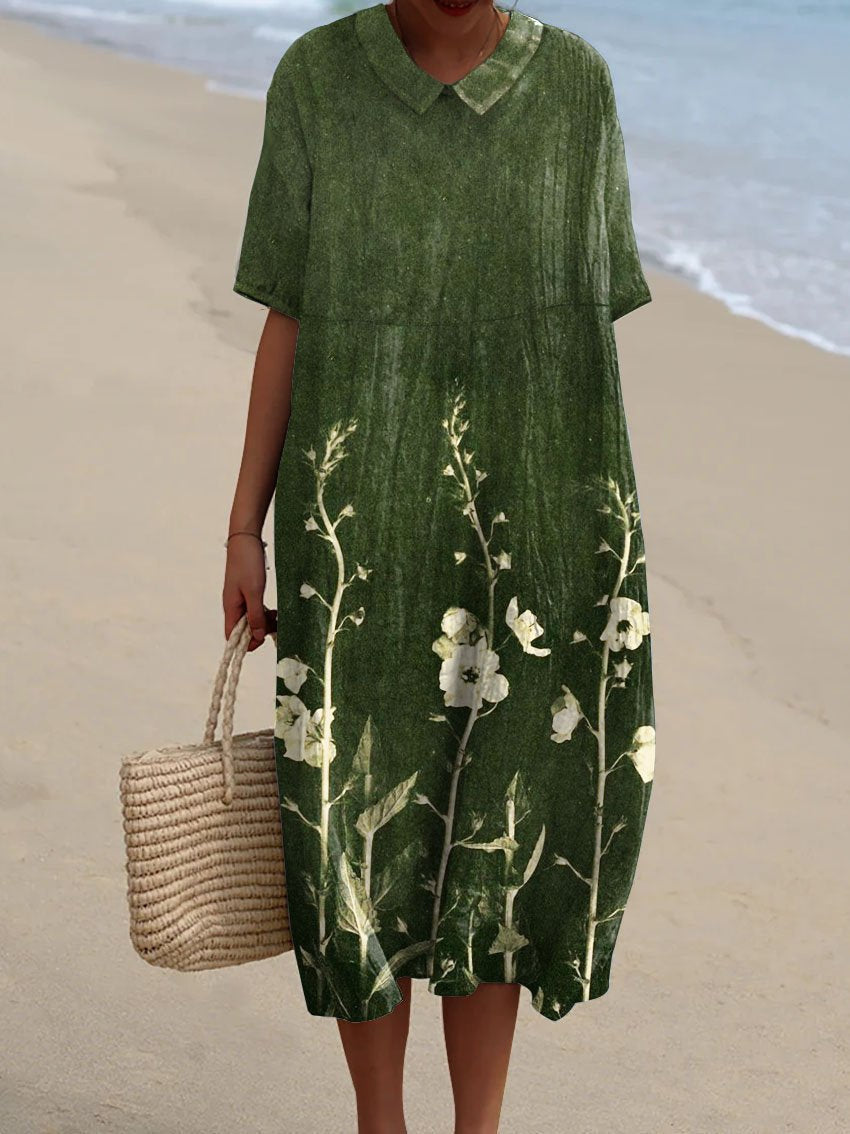 Robe florale éclatante Nicka de Danoir Paris, tissu léger avec motif floral coloré, portée élégamment sur un mannequin.