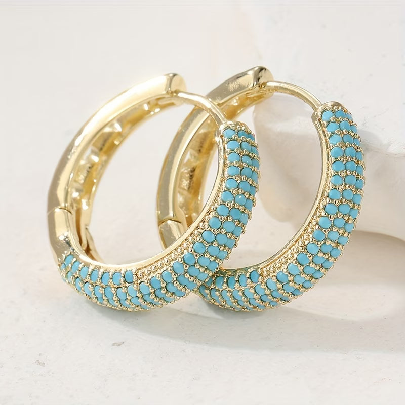 Boucles d'oreilles turquoise charmantes de Danoir Paris, en verre ou pierre, avec design élégant et moderne.