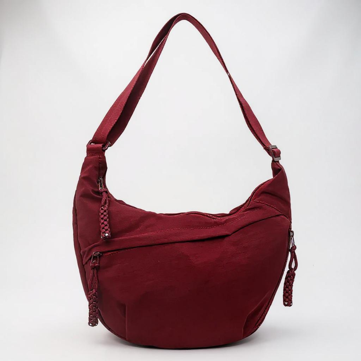 Sac à bandoulière Bordeaux Danoir Paris en cuir avec poignée et poches extérieures, style élégant et pratique.