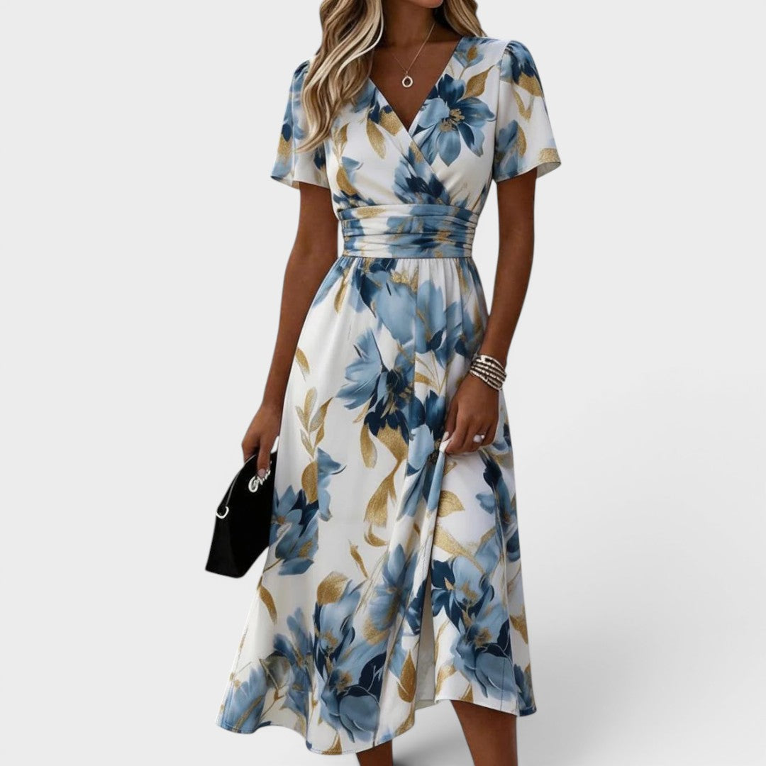 Robe midi fluide Denise de Danoir Paris avec motif floral, taille ceinturée et style wrap, portée élégante et féminine.