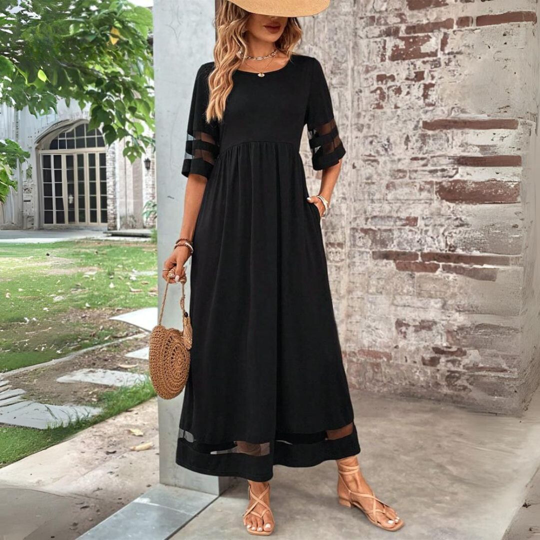 Robe midi Aubrée de Danoir Paris, coupe flatteuse, en tissu fluide, portée élégante avec décolleté en V et manches courtes.