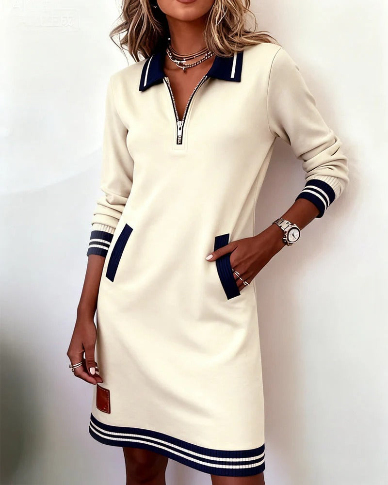 Robe sport chic élégante Nadege Danoir Paris, tissu fluide, design moderne, couleur neutre, portée décontractée et sophistiquée.