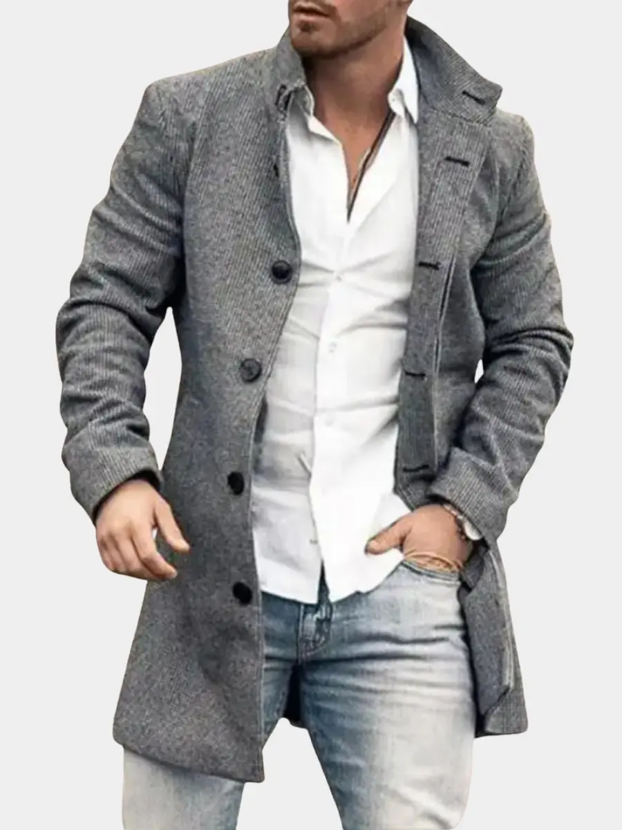 Manteau élégant pour homme Danoir Paris porté, tissu classique, coupe moderne, fond neutre.