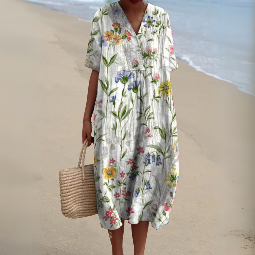 Robe fleurie élégante Nathalie de Danoir Paris, tissu fluide avec motif floral, coupe sophistiquée et détails raffinés.
