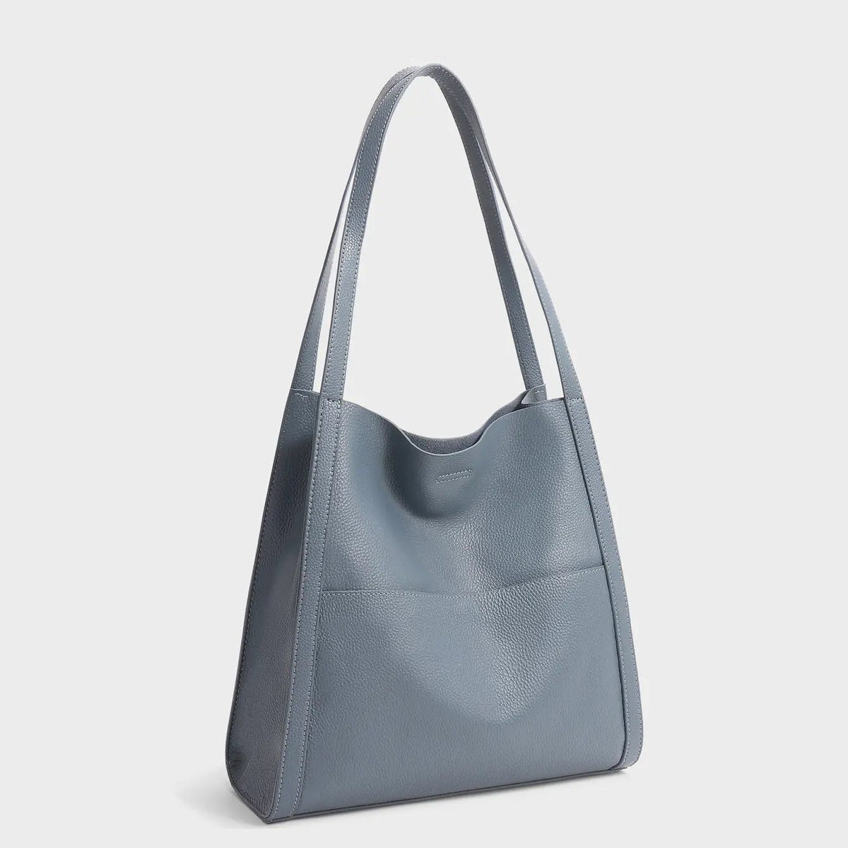 Sac à main en cuir marron Elise de Danoir Paris, élégant et sophistiqué, avec poignées et détails en cuir visible dans l'image.