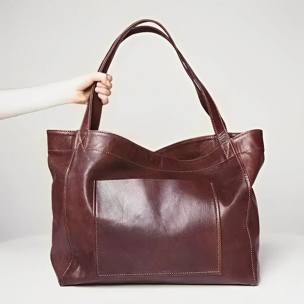Sac en cuir rétro Élise de Danoir Paris, design élégant, avec poignées et fermeture métallique visible sur l'image.