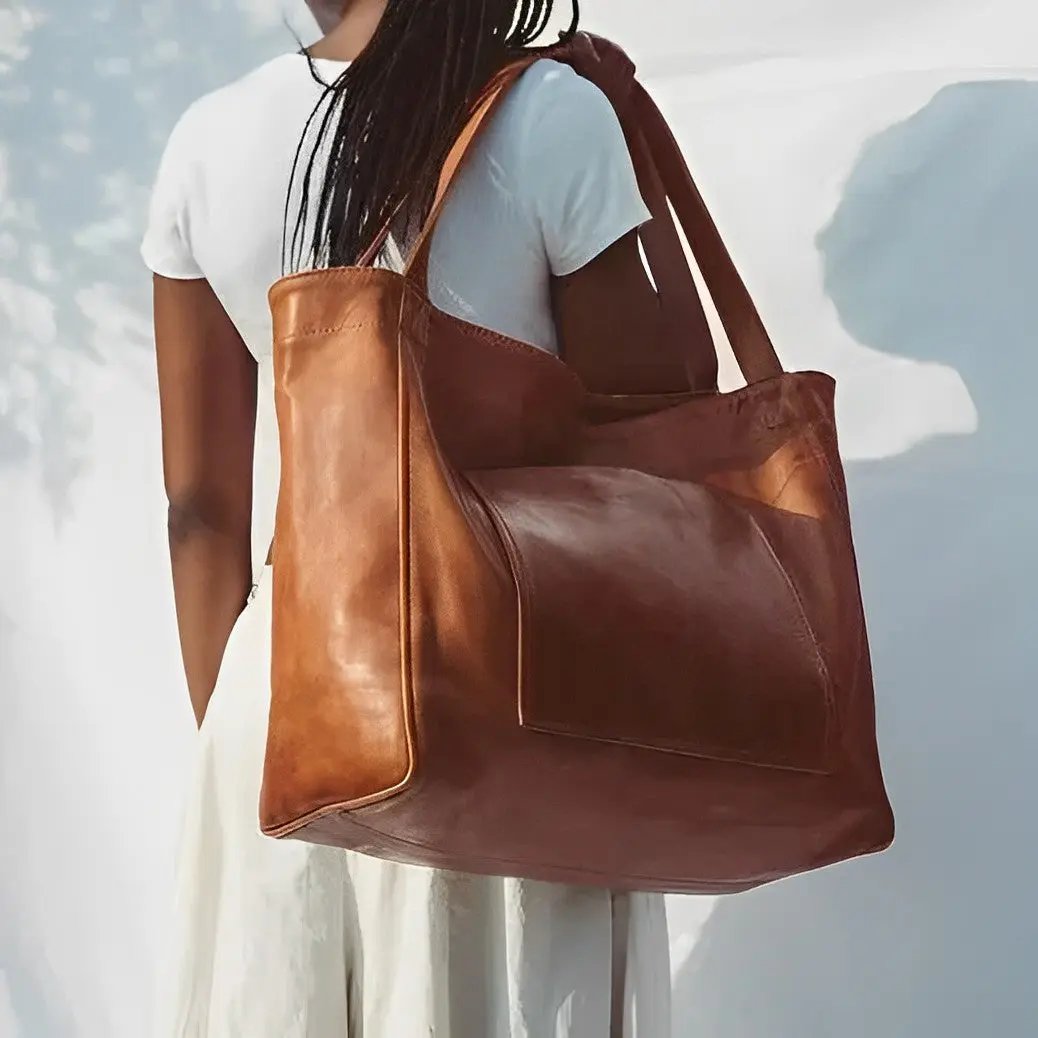 Sac en cuir rétro Élise de Danoir Paris, maroquinerie marron avec poignées et fermeture élégante, style vintage et sophistiqué.