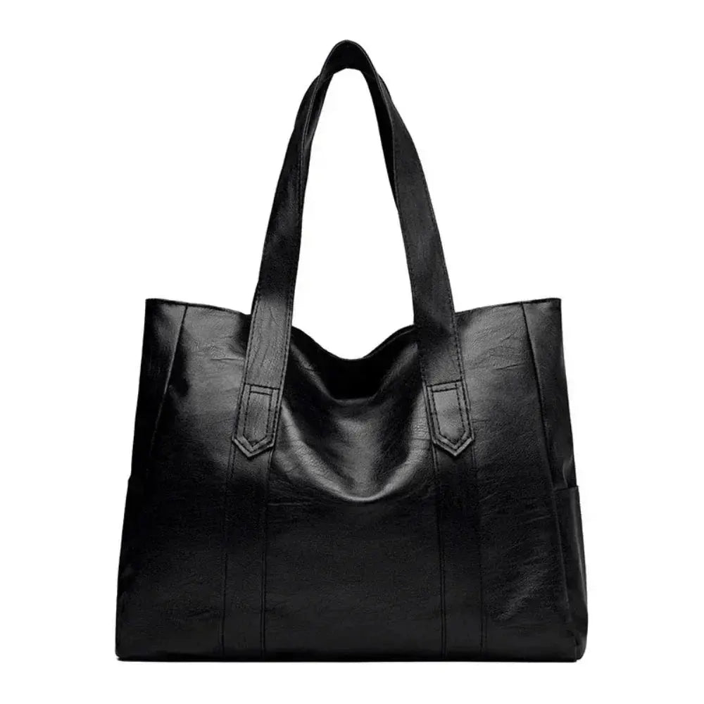 Sac à main minimaliste élégant Danoir Paris, en cuir, avec poignée fine et design épuré, sur fond neutre.