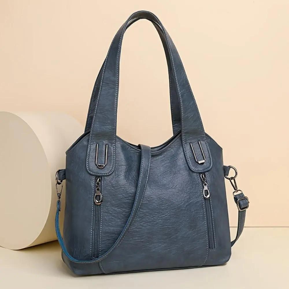 Sac à bandoulière Lydia Danoir Paris avec détail vintage, en cuir brun, élégant et compact pour un style chic et rétro.