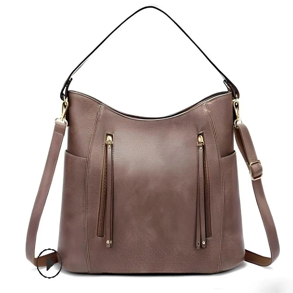 Sac à bandoulière en cuir vintage Danoir Paris, grande poche pour dames, design classique et élégant.