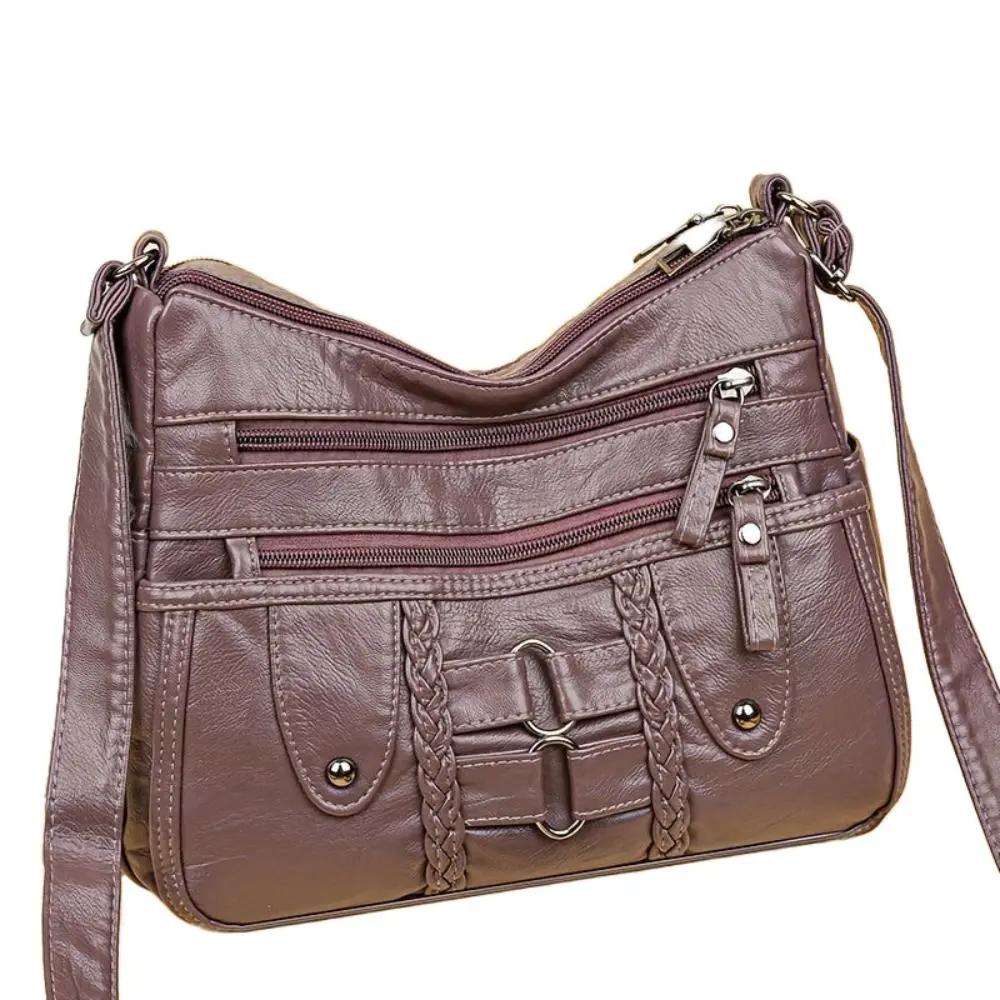 Sac bandoulière sécurisé Danoir Paris Ivy avec compartiments, en cuir élégant, visible avec fermeture sécurisée et détails modernes.