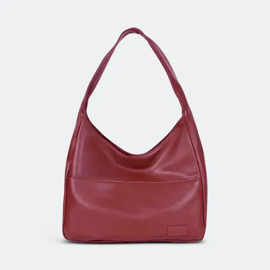Sac tote Danoir Paris Nina, sac à bandoulière simple et intemporel, en cuir noir avec poignée robuste et design épuré.