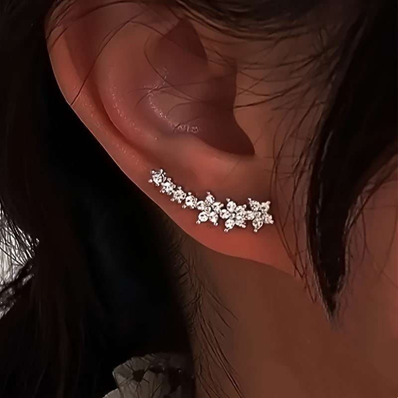 Boucles d'oreilles florales intemporelles en or rose signées Danoir Paris, détails délicats et élégants visibles sur l'image.