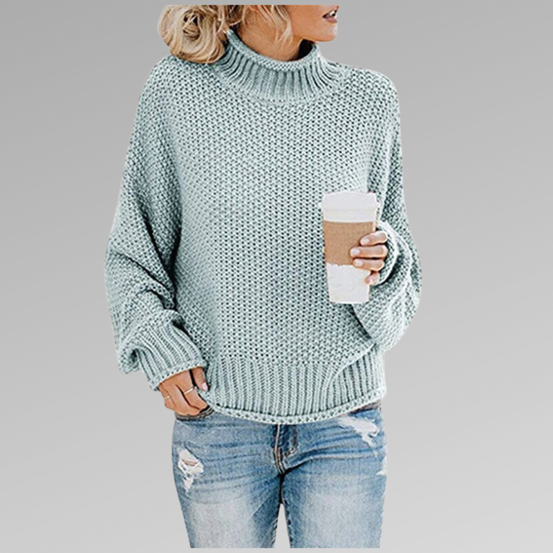 Pull décontracté et élégant Helena de Danoir Paris en orange, porté avec col en V et manches longues.