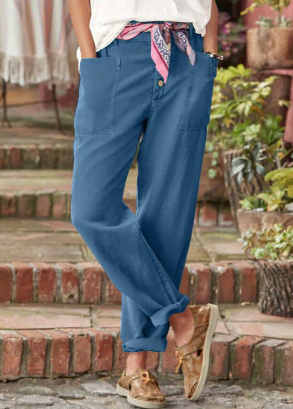 Pantalon élégant Danoir Paris Lise en tissu fluide, coupe ajustée, couleur neutre, porté avec une chemise blanche.