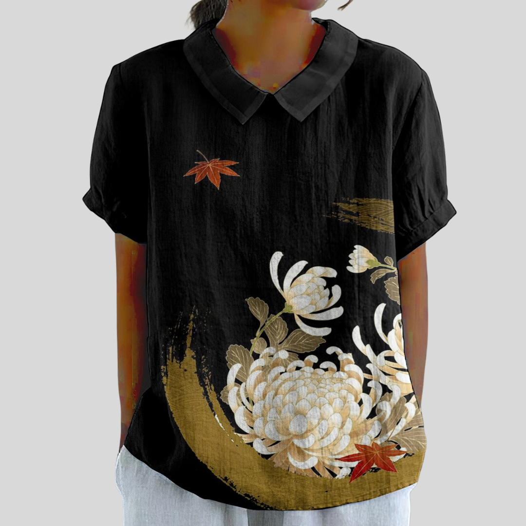 Blouse élégante Danoir Paris avec motif floral noir, tissu léger et coupe fluide, idéale pour un style sophistiqué.