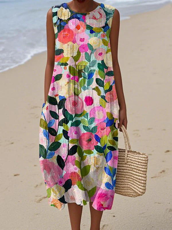 Robe midi sans manches Danoir Paris Ava, fleurie avec motif coloré, tissu léger et élégant, portée pour une occasion printanière.