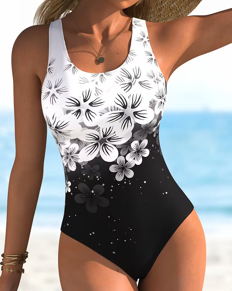 Maillot de bain une pièce Danoir Paris à imprimé fleuri noir, modèle Mode, avec décolleté et design élégant.