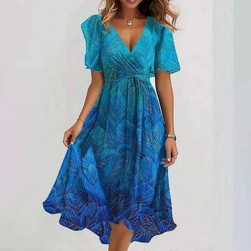 Robe florale élégante Danoir Paris avec motifs colorés, portée avec manches longues et coupe fluide, vue de face.