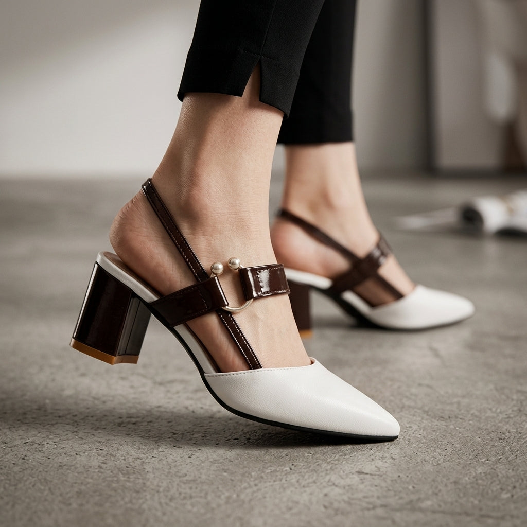 Mules à talons Danoir Paris Alana en cuir noir avec boucle décorative et talon moyen, vues de face et de côté.
